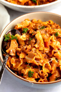 Bowl of homemade hamburger helper lasagna with ground beef and parsley