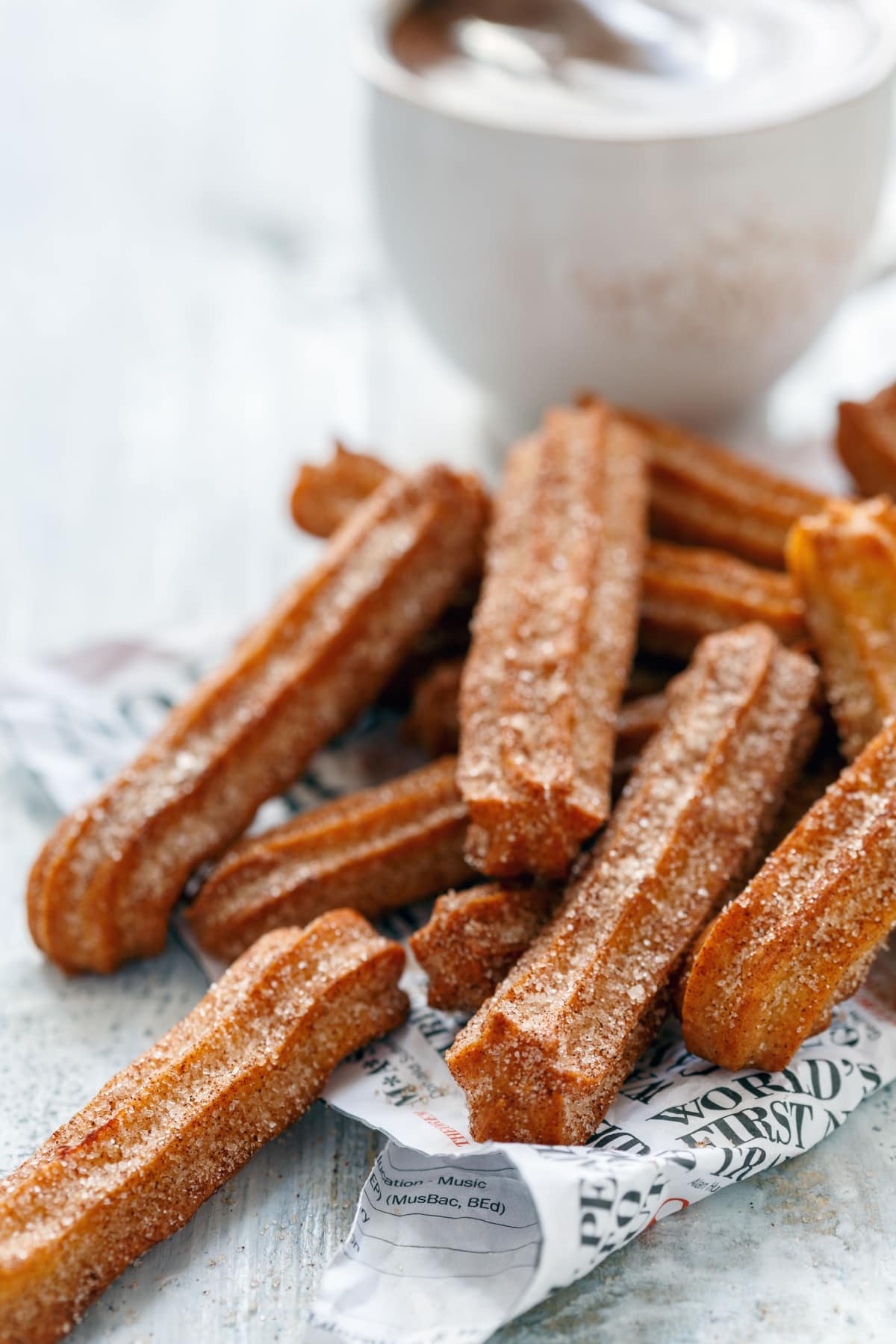 Bunch of churros coated with cinnamon sugar.