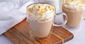 Caramel macchiato served in glass mug