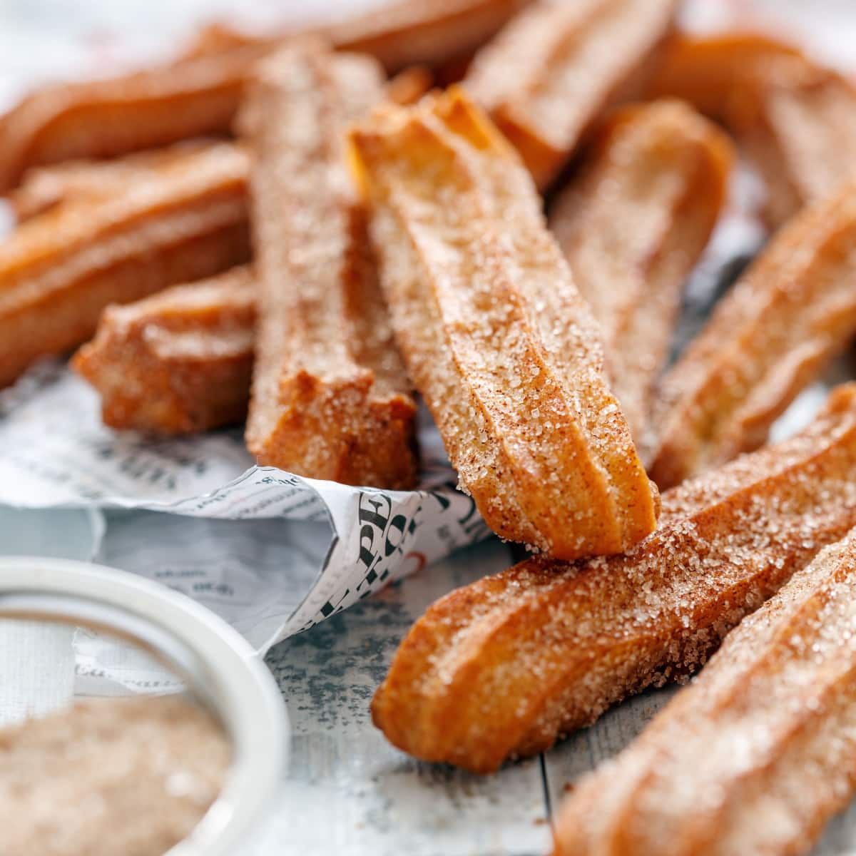 Bunch of perfectly golden cinnamon sugar coated churros- close up. 