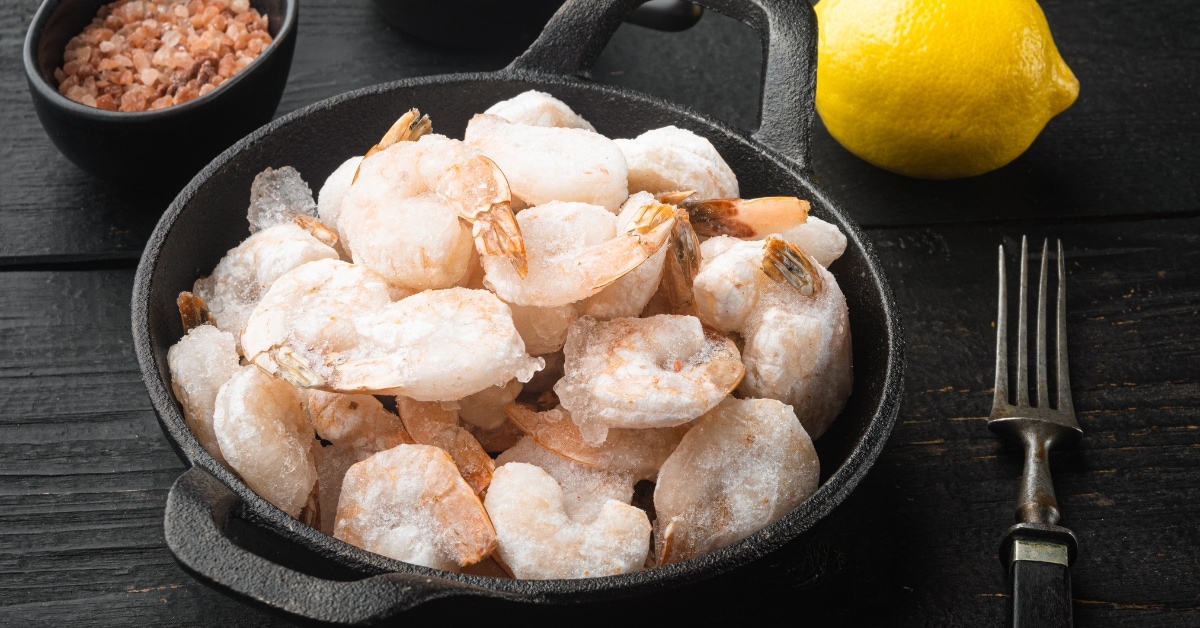 Frozen Shrimp in a Black Bowl with Lemon