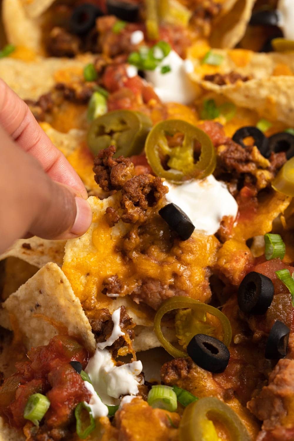 Homemade Loaded Super Nachos with Black Olives, Ground Beef and Jalapenos