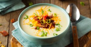 Homemade Warm Sweet Potato Soup with Bacon and Cheese in a Bowl