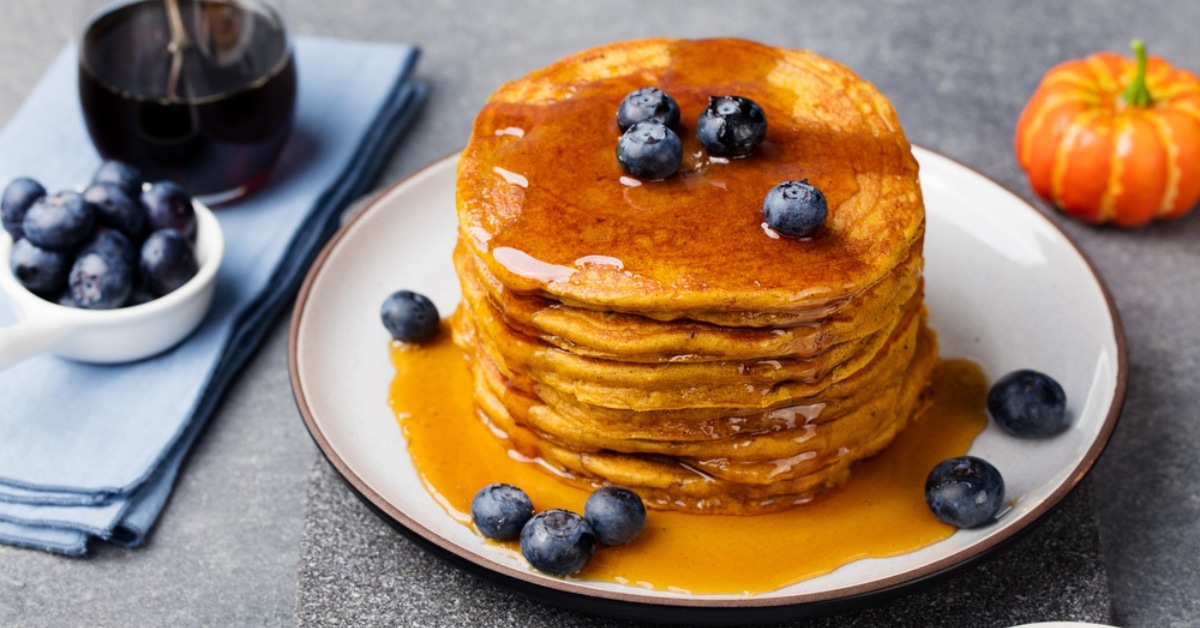 Pumpkin pancakes drizzled with syrup