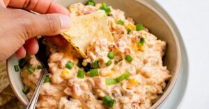 Man Dippin a Potato Chip into a Cheesy Cowboy Crack Dip