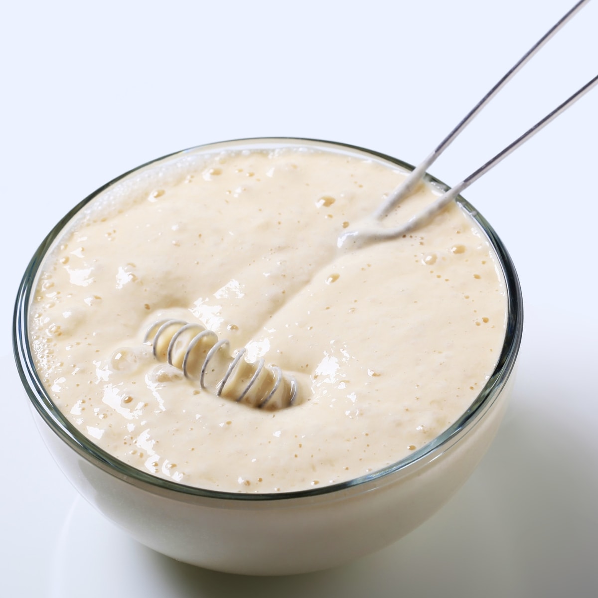 Pancake batter in a glass bowl.