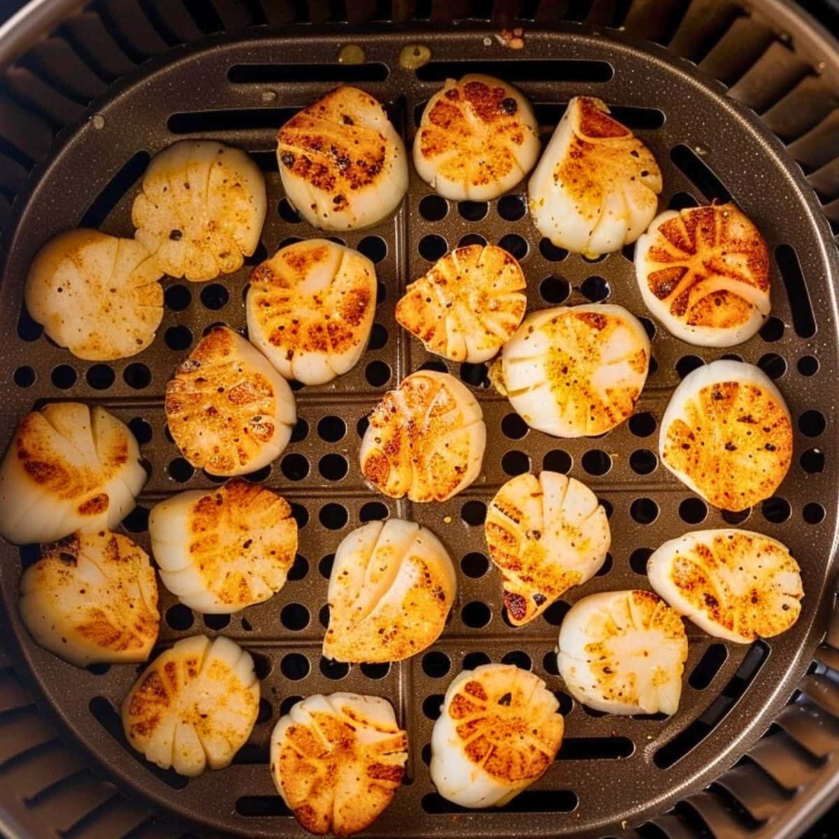 Scallops inside an air fryer basket.