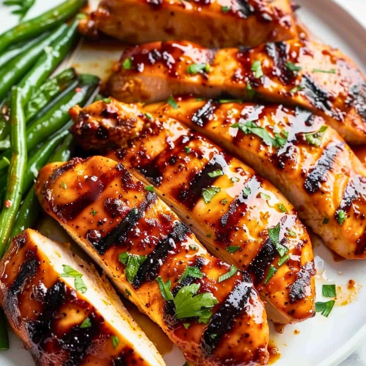 Sliced Carolina chicken served with green beans on the side.