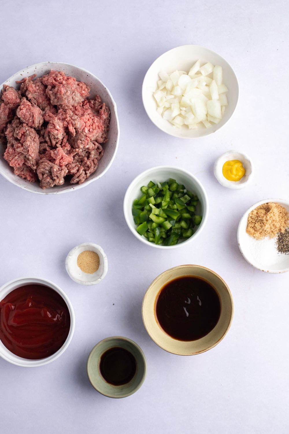 Sloppy Joes Ingredients: Ground Beef, Onions, Brown Sugar, Ketchup, Mustard, Barbecue Sauce, Worcestershire Sauce, Bell Pepper, Garlic Powder and Crusty Bread