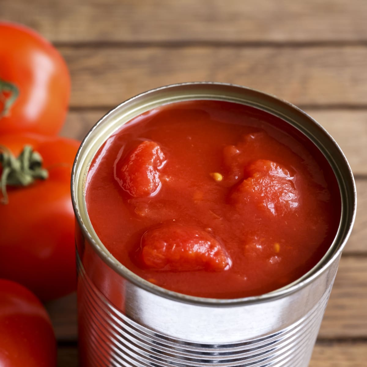 Opened can of peeled tomatoes. 