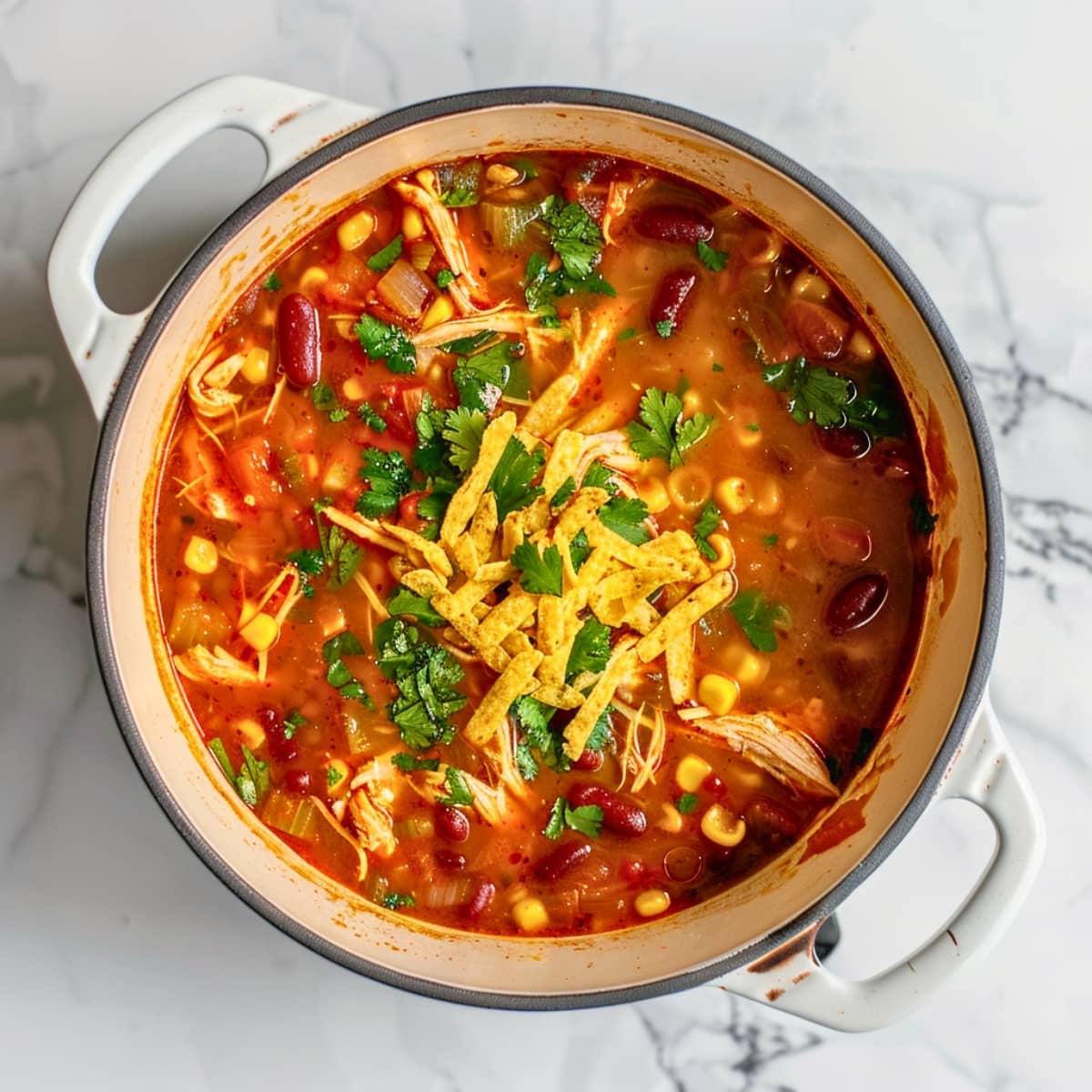 Top view of a pot with chicken tortilla soup.