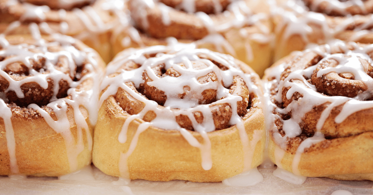 Cinnamon rolls topped with sugar glaze and cinnamon powder.